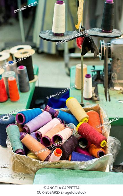 Spools of colorful threads and sewing equipment in fashion design studio