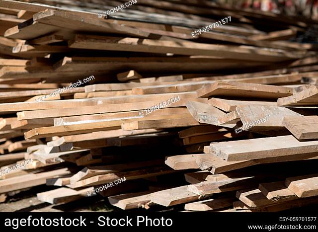 Wooden boards for repairing building are stacked outdoor