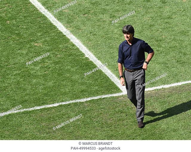 Germany's coach Joachim Loew inspects the pitch before the FIFA World Cup 2014 quarter final match between France and Germany at the Estadio do Maracana in Rio...
