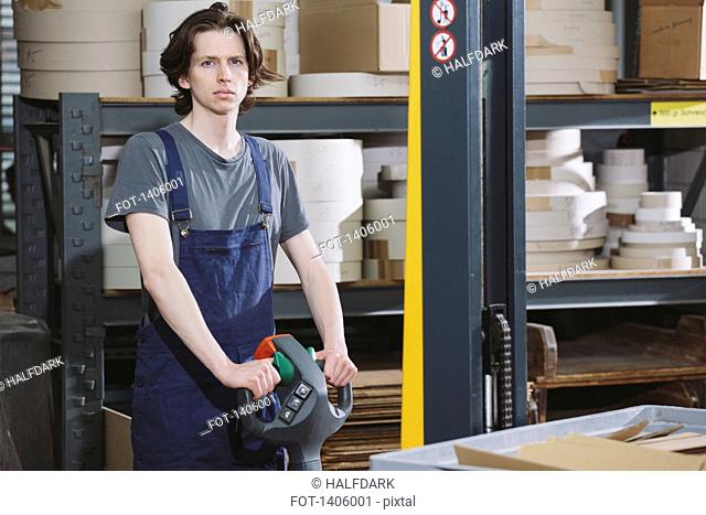Portrait of young male worker working in warehouse