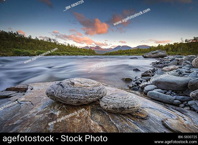 Two round stones lie on the river bank in the evening light, Abisko National Park, Lapland, Björkliden, Norrbottens län, Sweden, Europe