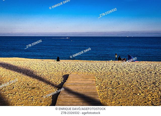View of a diagonal shadow line on Albir beach, Alicante north, Spain