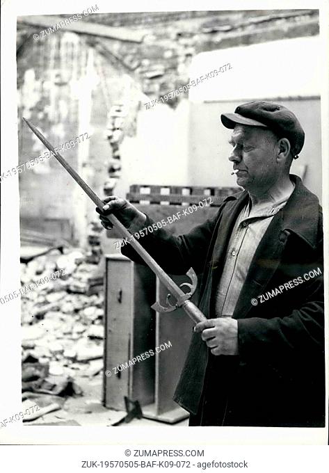 May 05, 1957 - Sword discovered during demolition of Holborn building. Scene of London Murder in 1949. Hidden among a pile of boxes are rubble on the roof of...