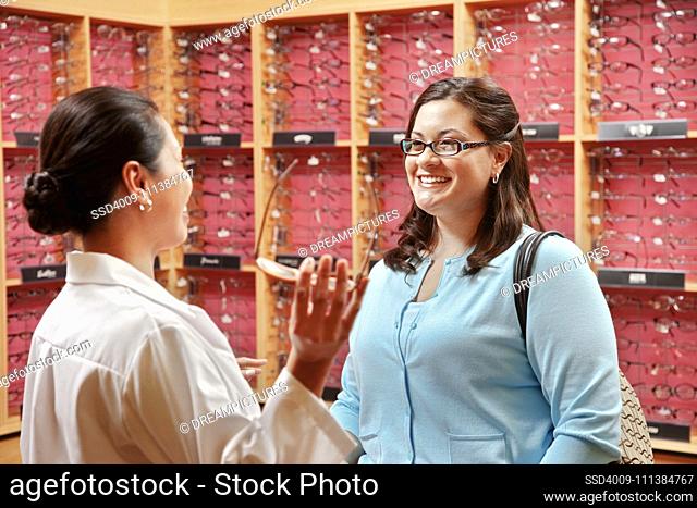 Optician helping customer select eyeglasses