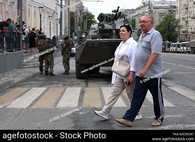 RUSSIA, ROSTOV-ON-DON - JUNE 24, 2023: Pedestrians walk past an armoured vehicle in Budyonnovsky Prospekt Street. Erik Romanenko/TASS