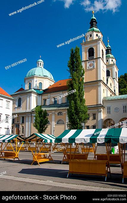 Market stalls outside of the Church of Saint Nicholas in Ljubljana, Slovenia, Europe