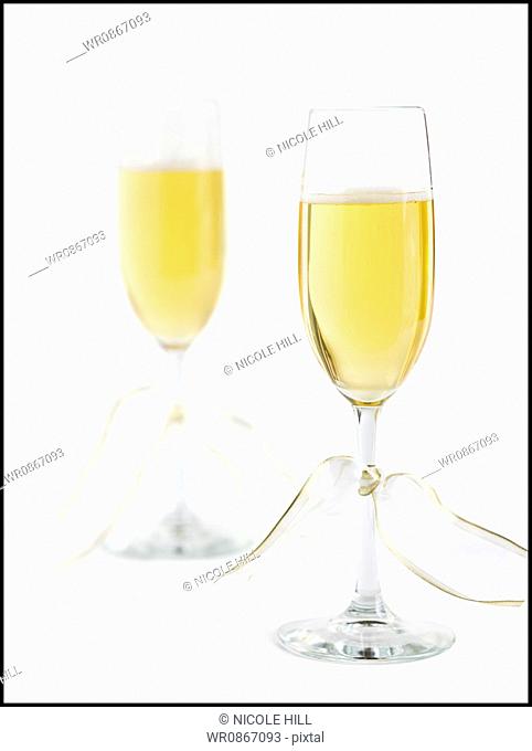 Two champagne flutes with champagne