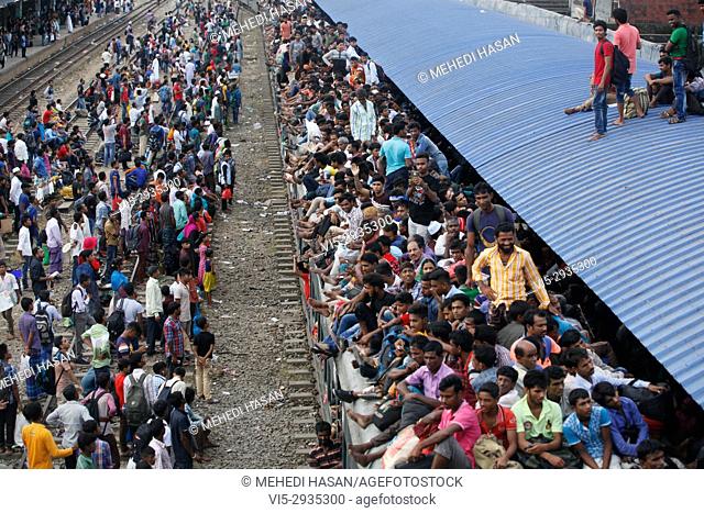 Bangladeshis cram onto a train as they travel home to be with their families ahead of the Muslim festival of Eid al Fitr, in Dhaka