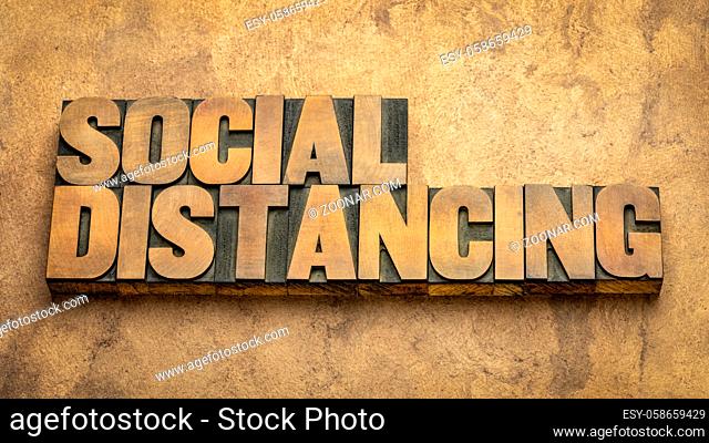 social distancing word abstract in vintage letterpress wood type - a set of nonpharmaceutical infection control actions to stop or slow down the spread of a...