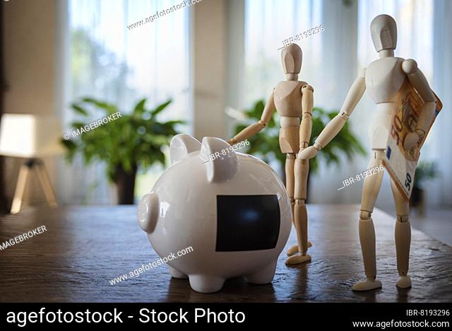 Piggy bank and mannequins carrying money