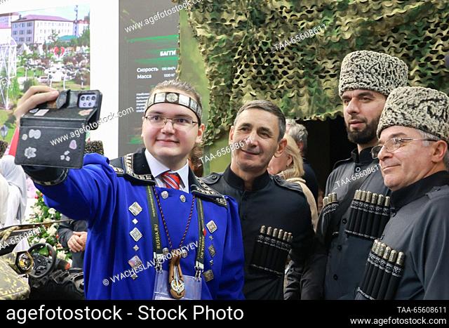 RUSSIA, MOSCOW - DECEMBER 10, 2023: People wearing traditional costumes are seen at the opening of Chechen Republic Day during the Russia Expo international...