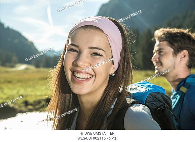 Austria, Tyrol, Tannheimer Tal, portrait of happy young woman wearing hair-band