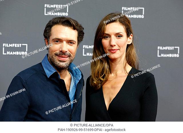 26 September 2019, Hamburg: French actors Doria Tillier (r) and Nicolas Bedos walk the red carpet at the opening of the Hamburg Film Festival
