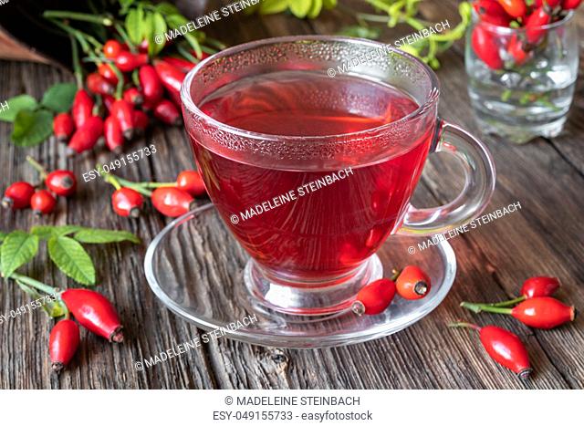 A cup of rose hip tea with fresh berries