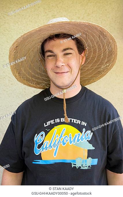 Smiling Young Man Wearing Large Straw Hat