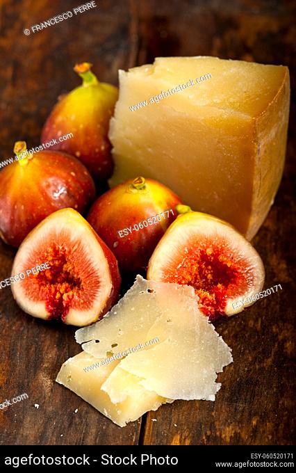 italian pecorino cheese and fresh figs macro closeup over old wood boards