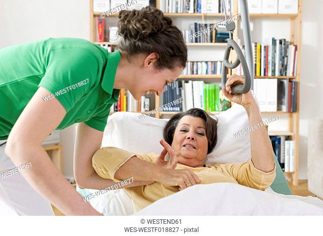 Germany, Leipzig, Mid adult woman helping senior woman