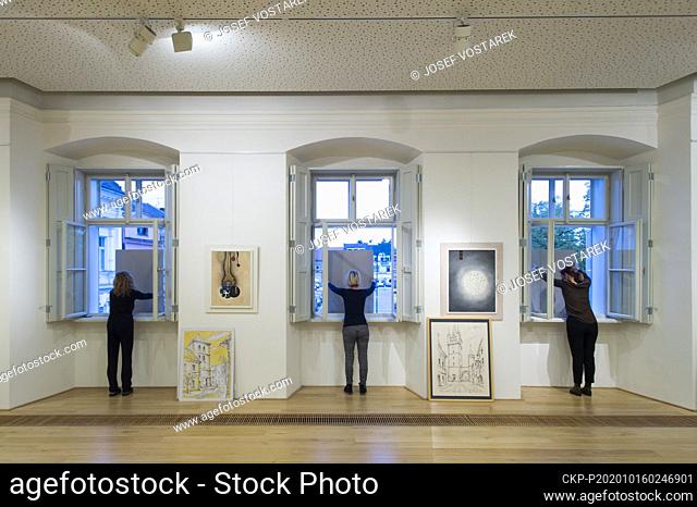 Curators show images from the windows due to coronavirus restrictions during the vernissage of paintings in Gallery in Vysoke Myto, Czech Republic, October 16