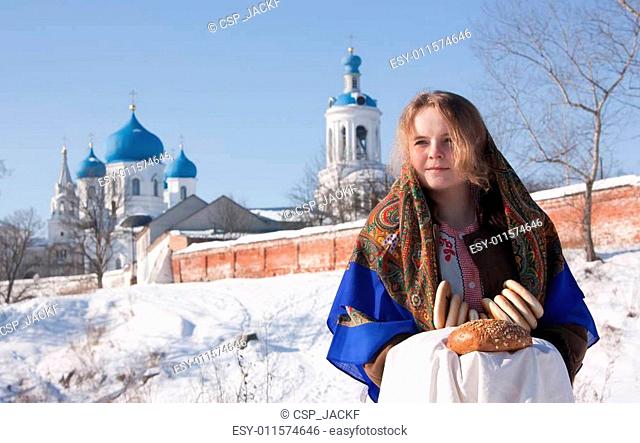 girl in russian traditional clothes with round cracknel