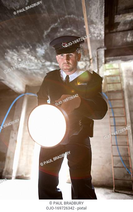 Security guard shining flashlight into bunker
