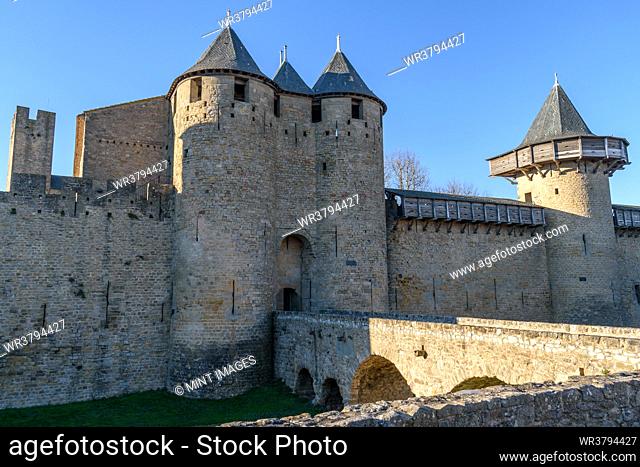 The Château Comtal, Count’s Castle, is a medieval castle in the Cité of Carcassonne, tall towers and wall, and a bridge to a fortified gate