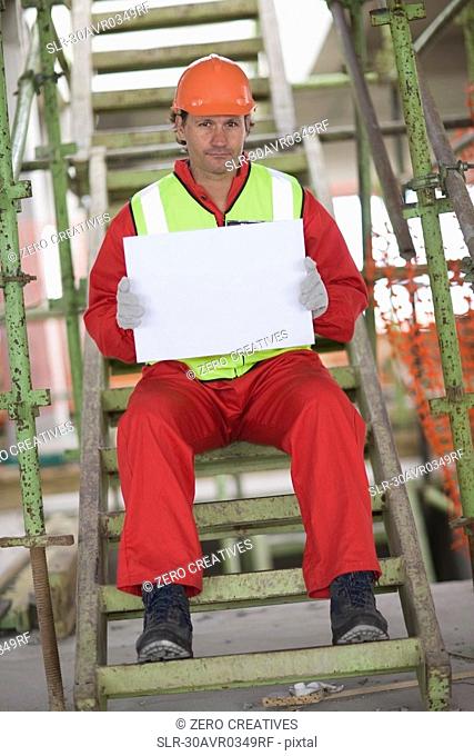 Worker holding an empty sheet of paper