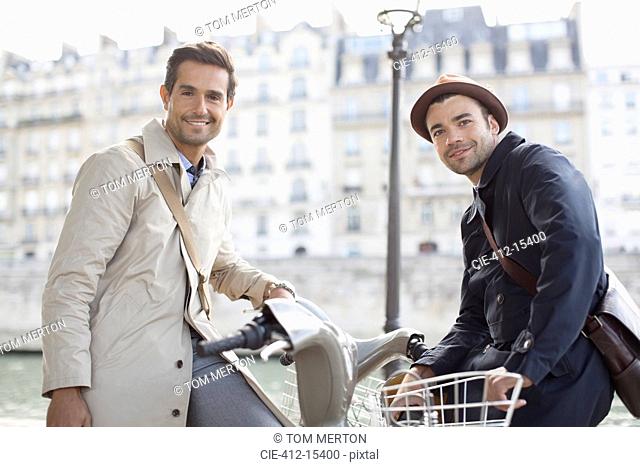 Businessmen on bicycles along Seine River, Paris, France