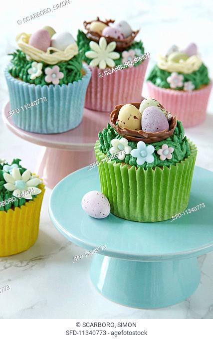 Easter cupcakes topped with cream and sugar decorations
