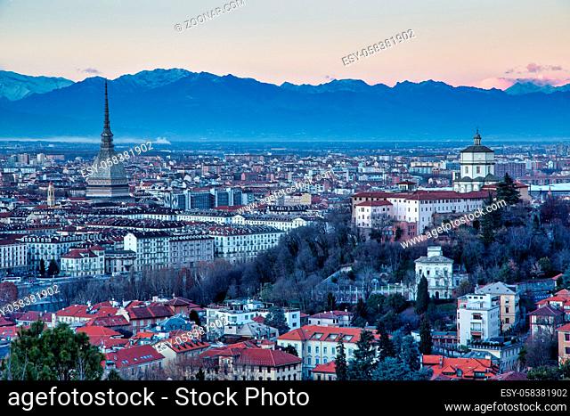TURIN, ITALY - CIRCA AUGUST 2020: panoramic view with skyline at sunset. Wonderful Alps mountains in background