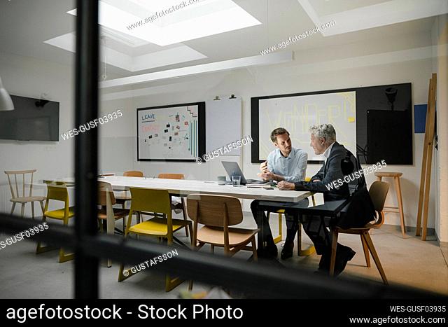 Entrepreneurs having a meeting in modern office, talking business