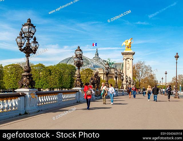 Paris, France, March 31, 2017: Pont Alexandre III in Paris, spanning the river Seine. Decorated with ornate Art Nouveau lamps and sculptures
