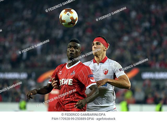 Belgrade's Srdan Babic and Cologne's Jhon Cordoba (L) vie for the ball during the Europa League match between 1.FC Cologne vs