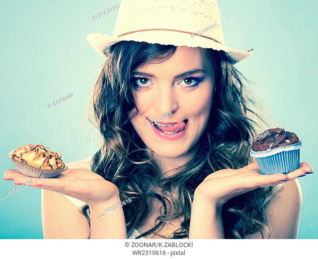 Smiling summer woman holds cakes in hand