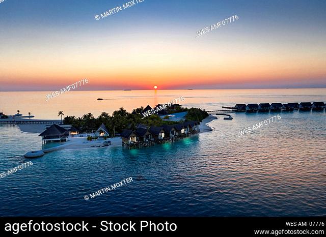 Maldives, South Male Atoll, Aerial view of lagoon of the Maldives island of Maadhoo at sunset