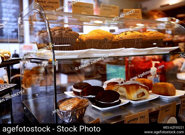 Cakes and muffins displayed inside bakery