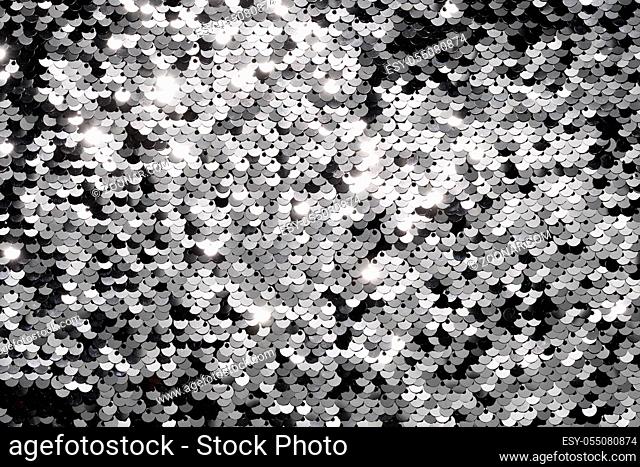 Sequin fabric background. Close-up shot of glittery black sequins texture