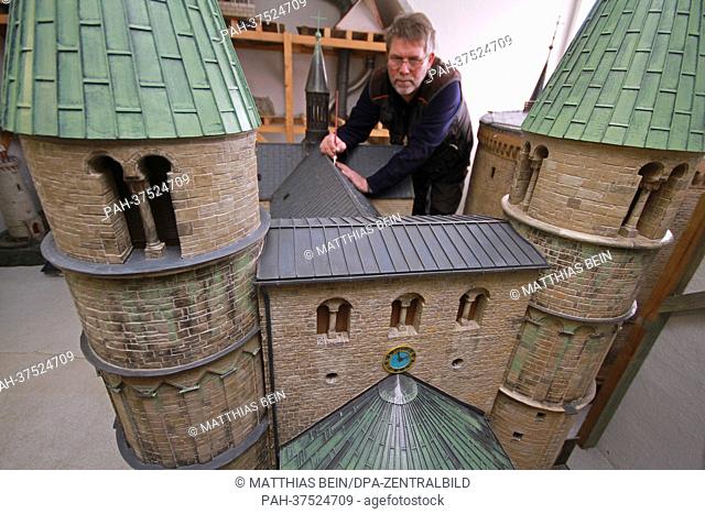 Staff member Axel Alm works on the miniature model of the collegiate church of Gernrode at the miniature exhibition park 'Kleiner Harz' in Wernigerode, Germany