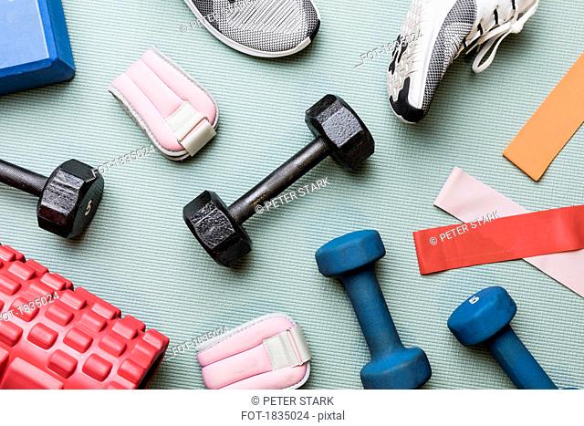 View from above dumbbells and exercise equipment - knolling