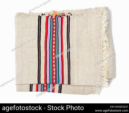 folded gray woven linen towel with colorful inserts isolated on a white background
