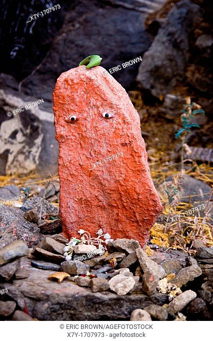 A painted stone with eyes along the path up Girnar Hill, a pilgrimage site for both Jains and Hindus  Junagadh, Gujarat, India