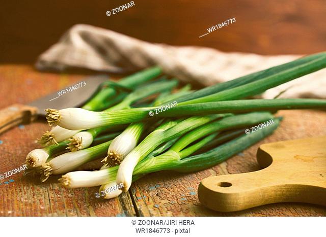 spring onion on old wooden table