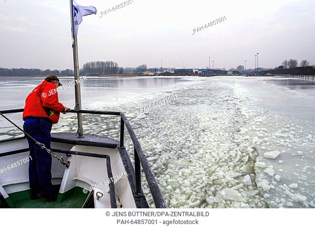 A crew member watches as the buoy tender 'Goermitz' that is used as an icebreaker cracks an ice sheet measuring more than 15 centimetres on Szczecin Lagoon near...