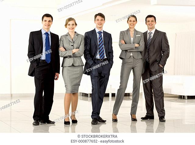 Portrait of confident business group standing in row and looking at camera