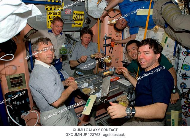 The Expedition 20 crew members share a meal in the Unity node of the International Space Station. Pictured (from the left