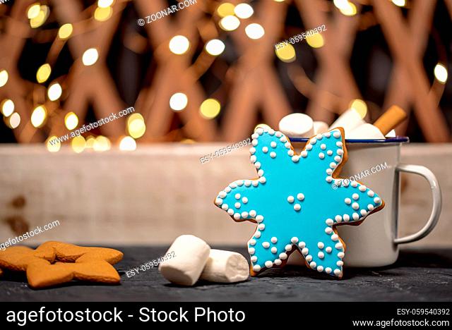 Bright christmas background with gingerbreads and white mug with marshmallow