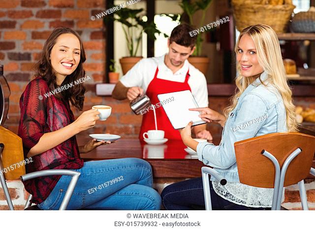 Handsome waiter preparing a cup of coffee
