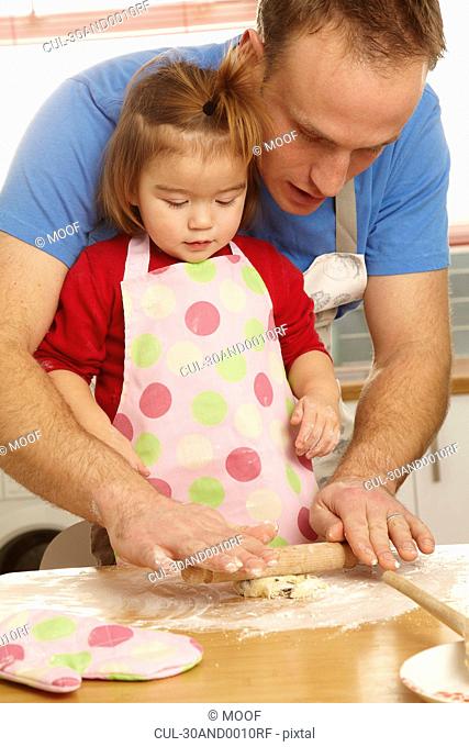 Father and daughter cooking together
