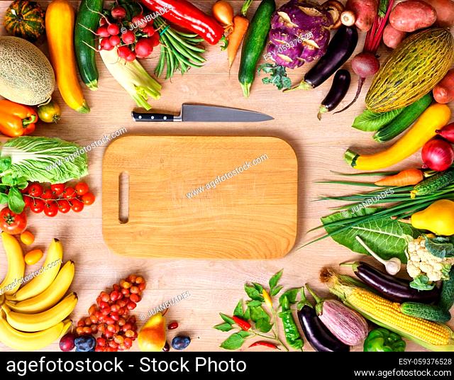 Healthy food background and Copy space / studio photography of wooden board surrounded by fresh vegetables on wooden table