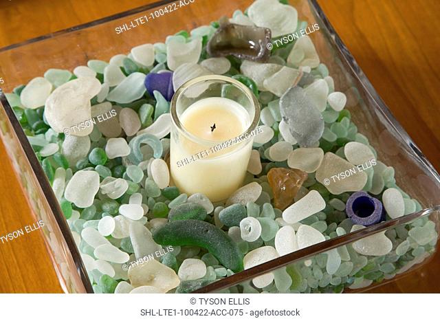 Centerpiece with candle and colorful smoothed glass