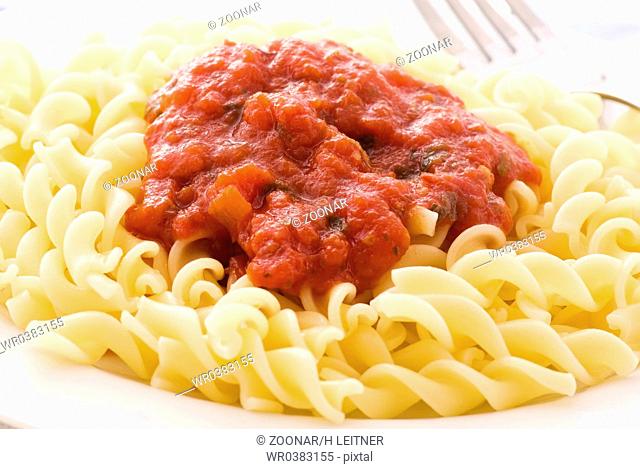 Fusilli with tomato sauce as closeup on a white plate